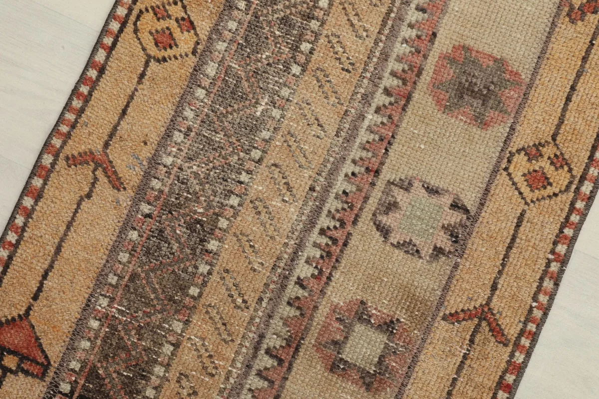 Close-up detail of the runner's hand-knotted wool pile and geometric motifs
