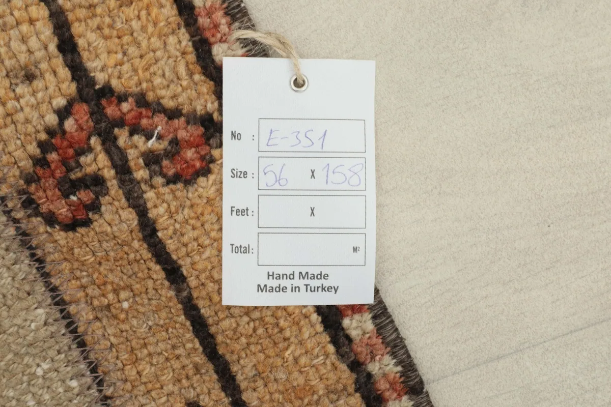 Close-up of the rug's tag, indicating its handmade origin and dimensions