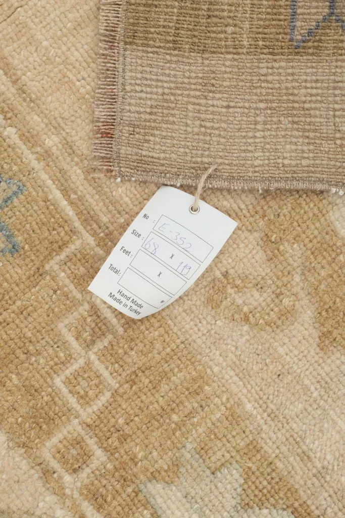 Close-up of the tag showing rug specifications like size and hand-knotted origin.