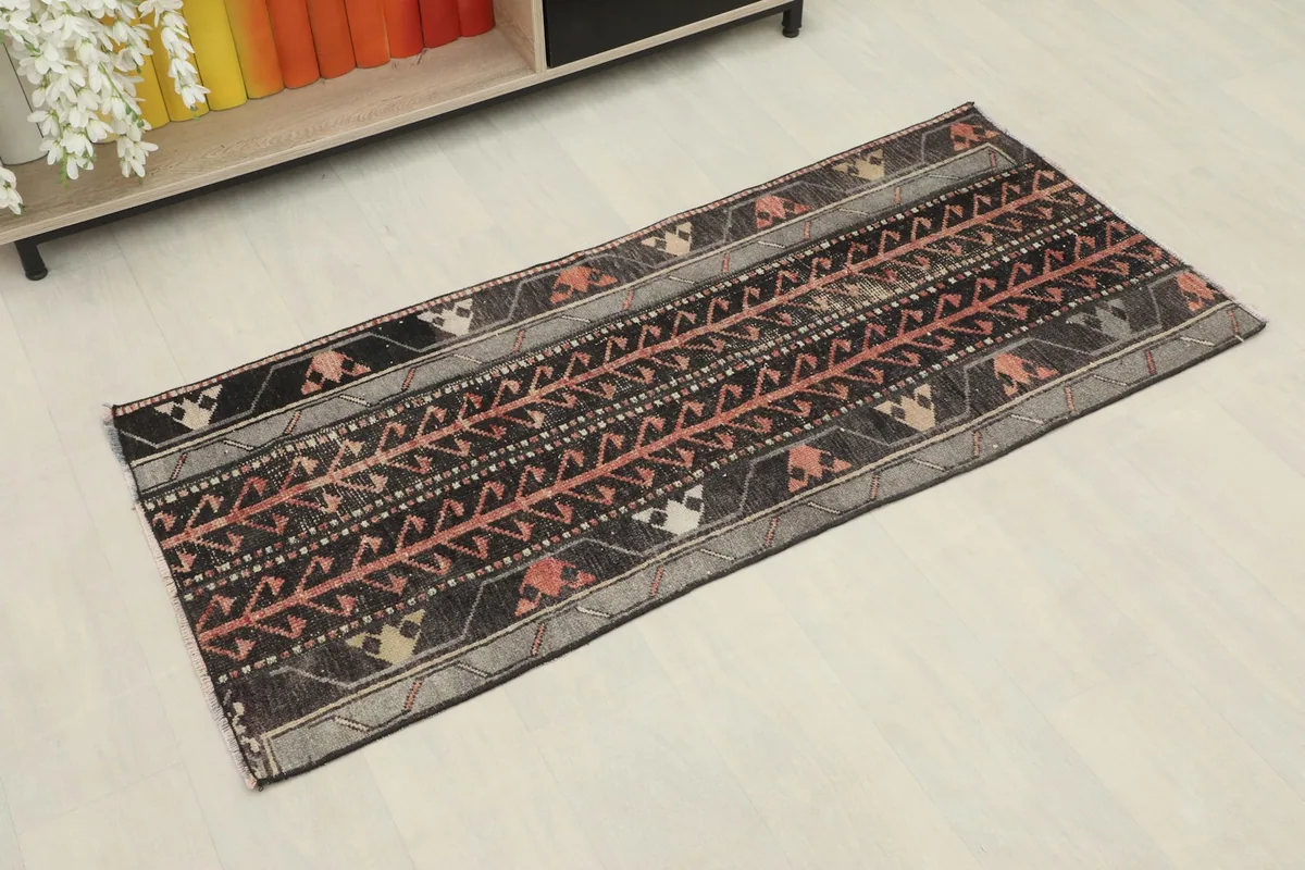 Angled view of the vintage Anatolian runner showcasing its geometric patterns and colors