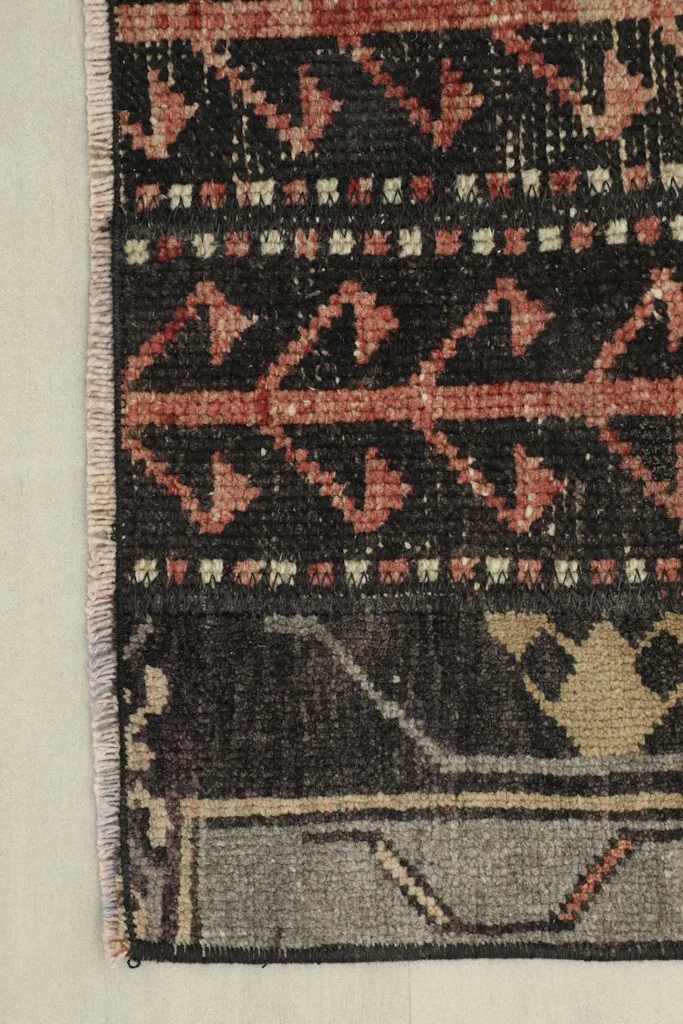 Edge detail of the runner, showing the gray border and fringe