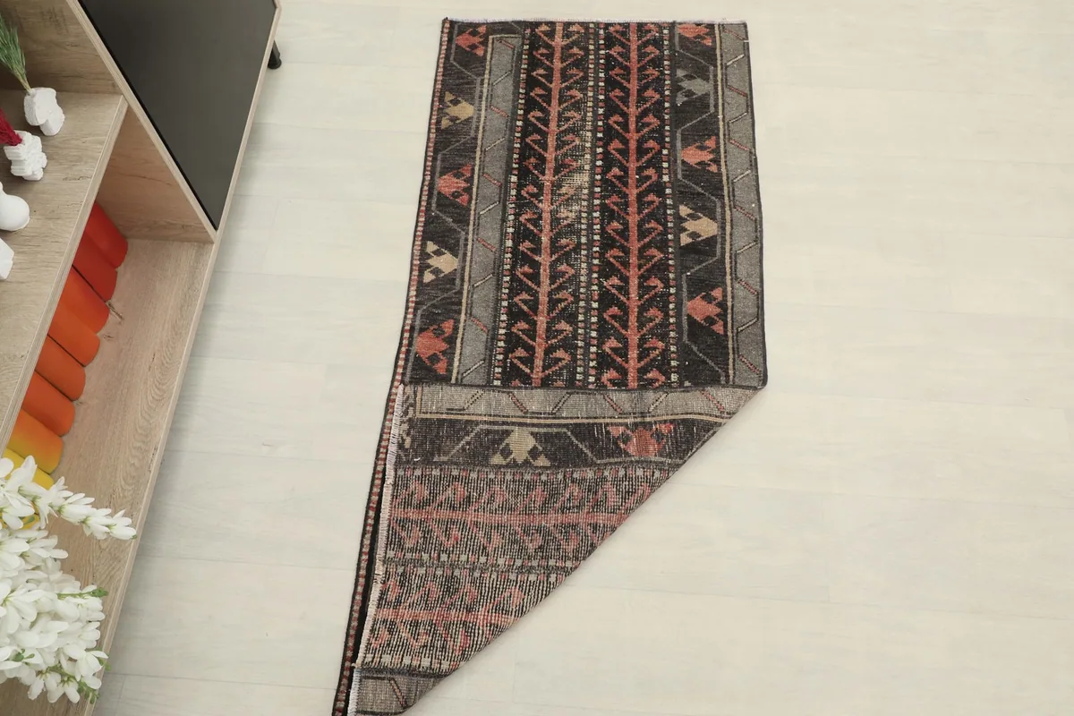 The vintage runner partially folded, showing its flexibility and texture