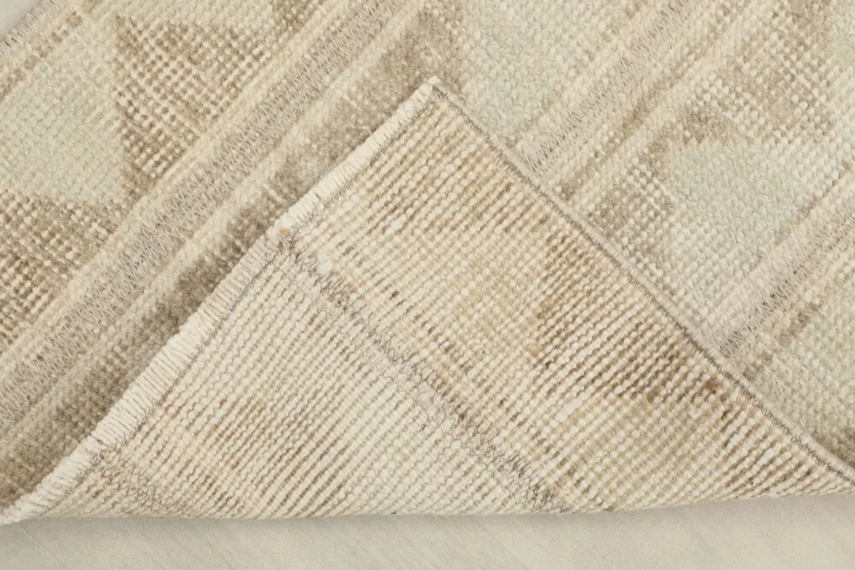 View of the back of the hand-knotted runner, revealing the cotton foundation and knot structure.