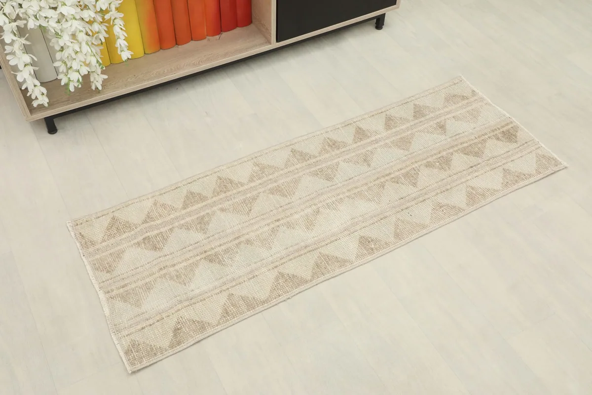Overhead view of the vintage runner rug, showing its full length and geometric pattern.