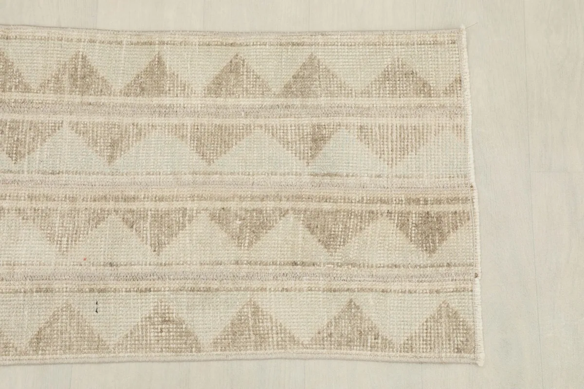 Overhead view of one half of the runner, emphasizing the repeating triangular geometric motifs.