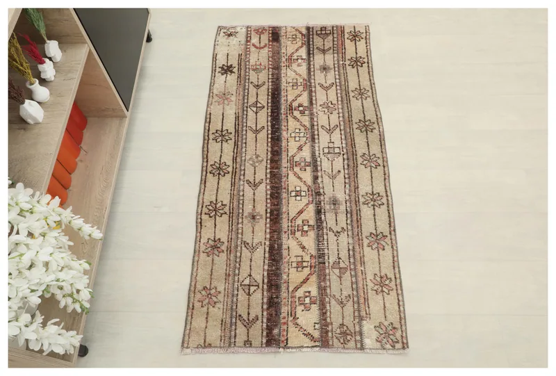 Full top view of the beige and brown striped vintage Anatolian rug on a white background.