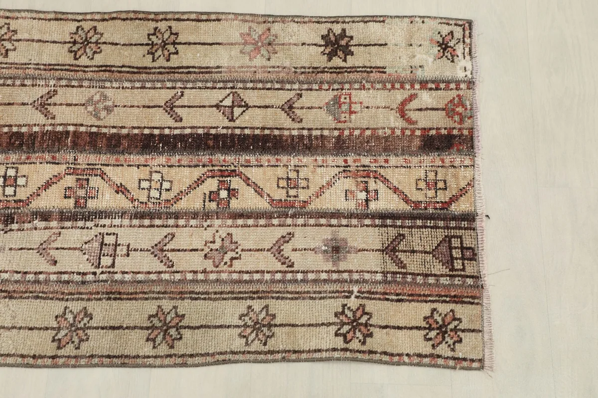View of one end of the rug, detailing the striped patterns and overall texture.