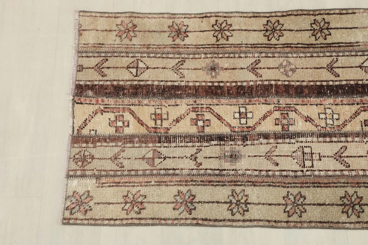 View of the opposite end of the rug, showing the consistent striped design and color palette.