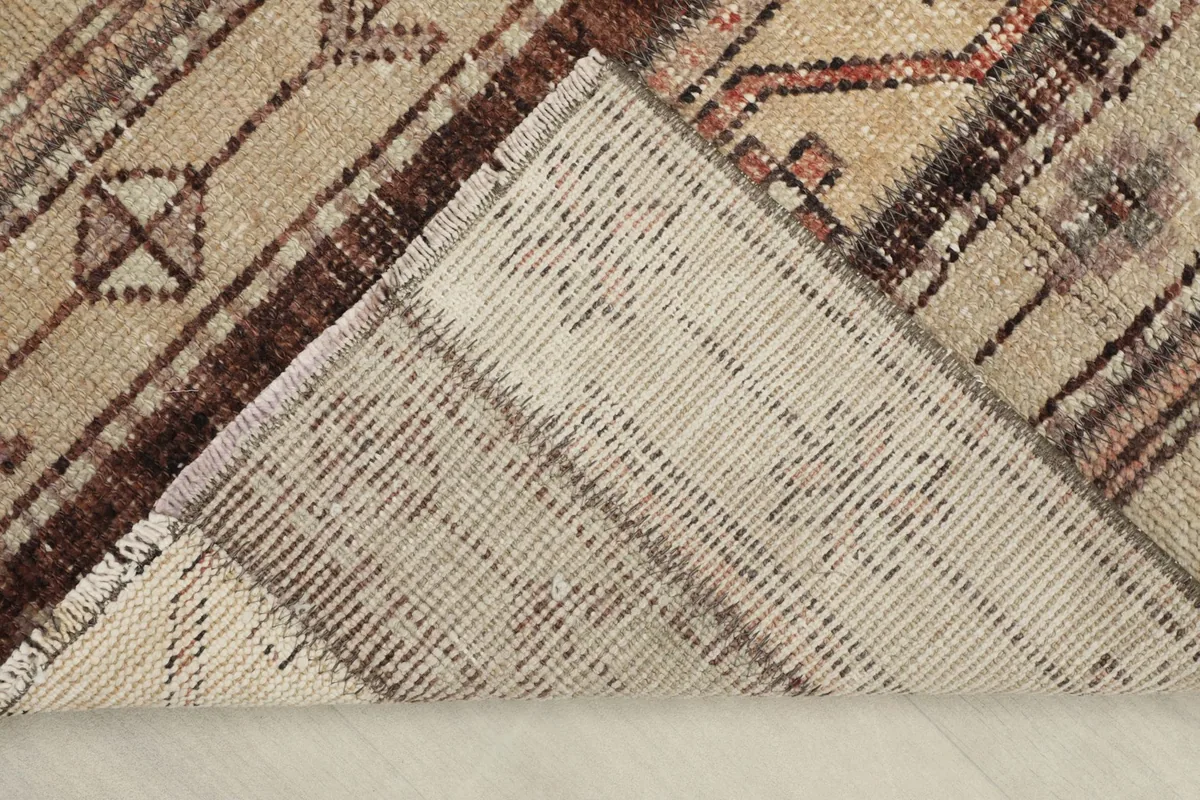 Underside view of the rug, showing the cotton foundation and hand-knotted construction.