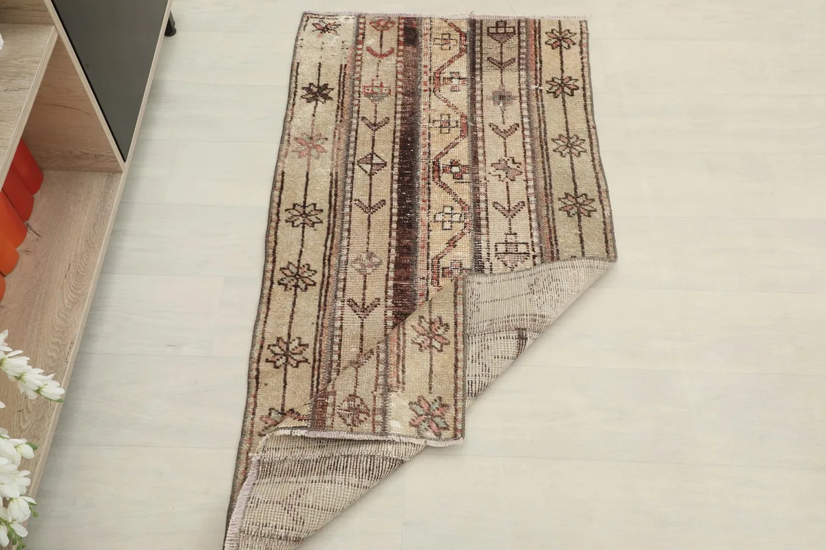 The rug partially folded, displaying both the pile and the reverse side.