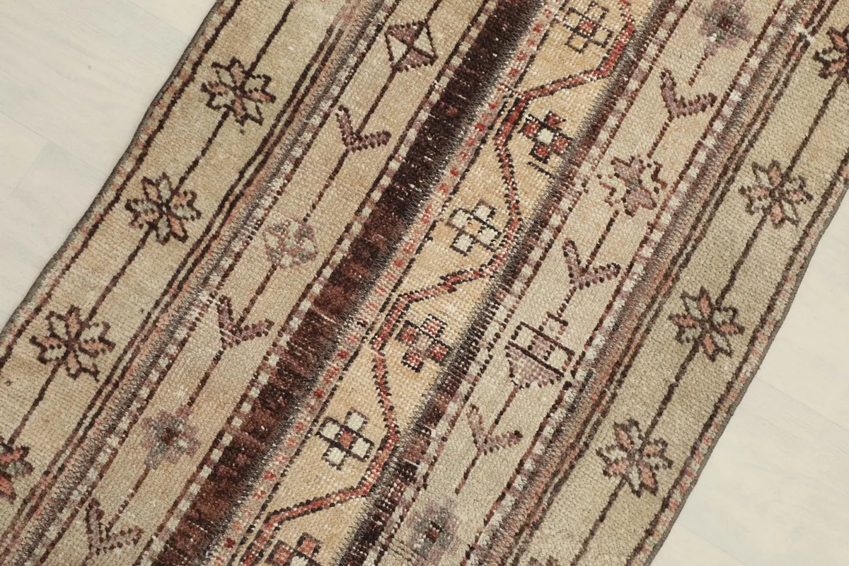 Close overhead view of the rug's central design, highlighting the striped geometric patterns.