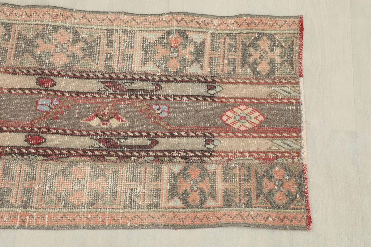 Detailed view of the rug's side, highlighting the geometric border and central patterns