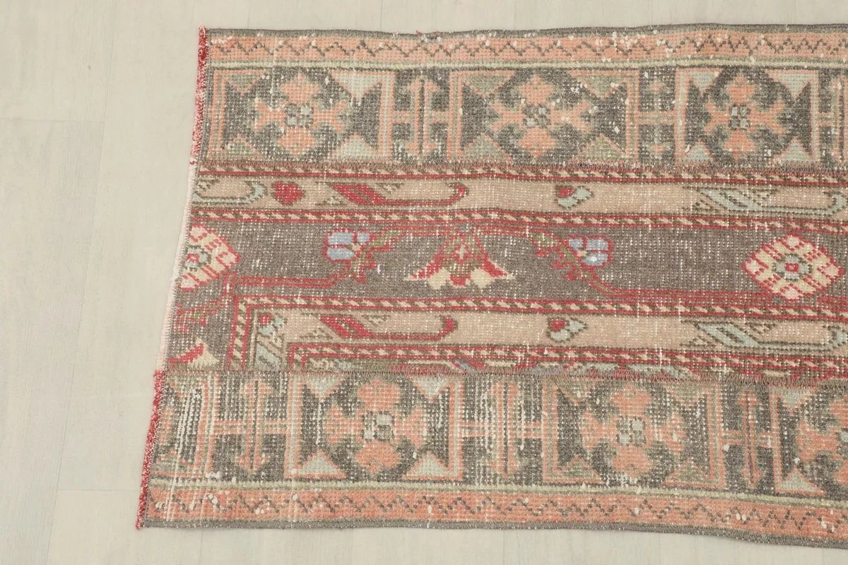 Close-up of the rug's other side, showing the intricate hand-knotting and faded colors