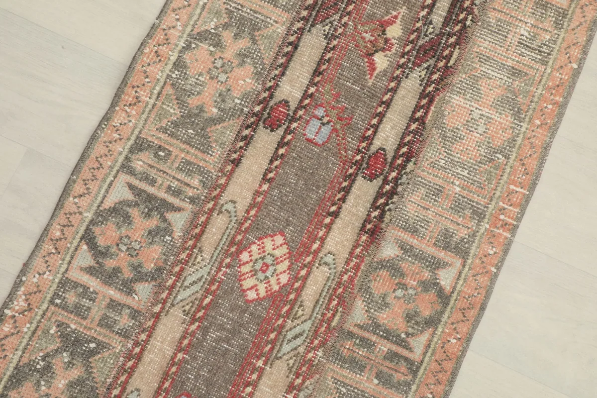 Close-up overhead view of the runner rug's central design and color variations