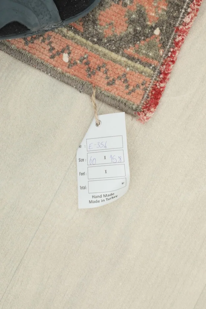 Close-up of the rug's corner with a tag showing its size and origin