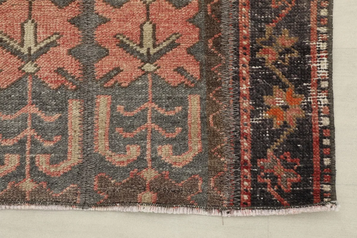 Corner detail showing the rug's border design and fringe