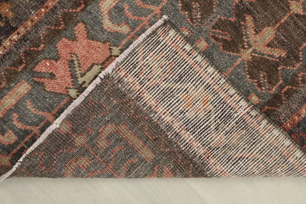 View of the rug's reverse side, revealing the hand-knotted cotton foundation