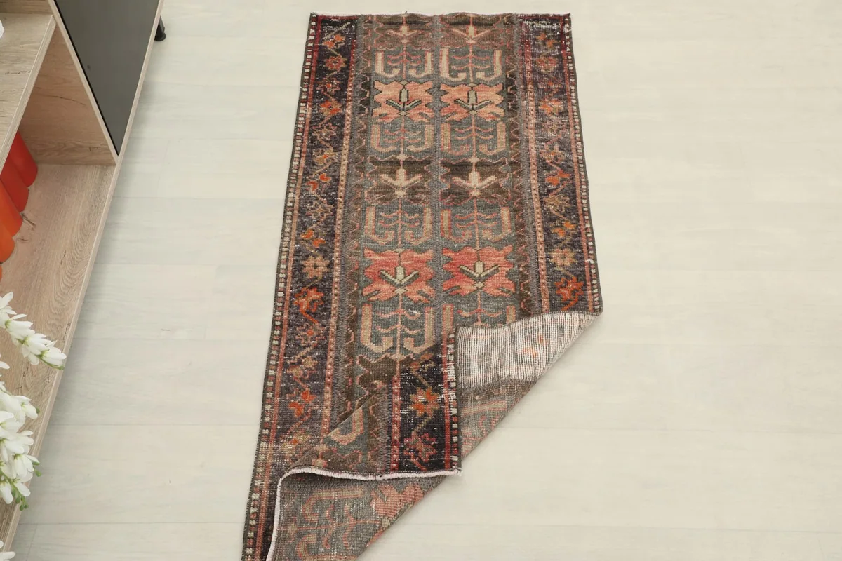 Full view of the rug with a corner folded back to show the pile and foundation