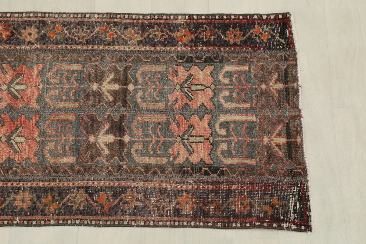 Overhead view of the rug's upper section, highlighting the repeating tribal patterns
