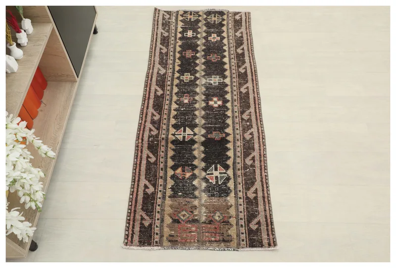Full top view of the 1'11" x 4'10" black and beige geometric runner rug