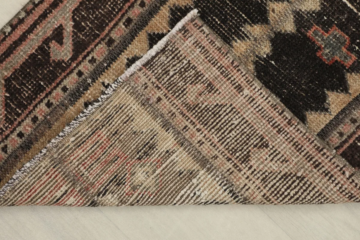 View of the rug's underside, revealing the hand-knotted cotton foundation
