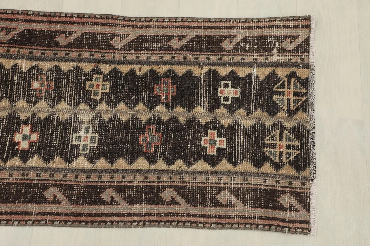Overhead view showing the top half of the runner rug and its patterned border