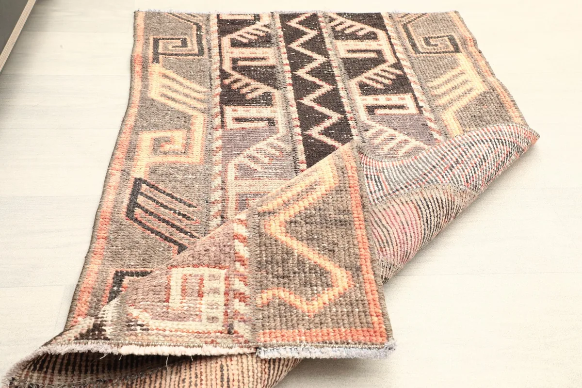 The rug folded to display its thickness and the reverse side texture.