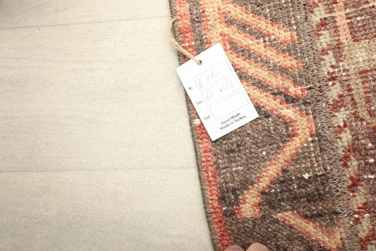 Corner of the rug with a 'Hand Made in Turkey' tag, indicating its origin and craftsmanship.
