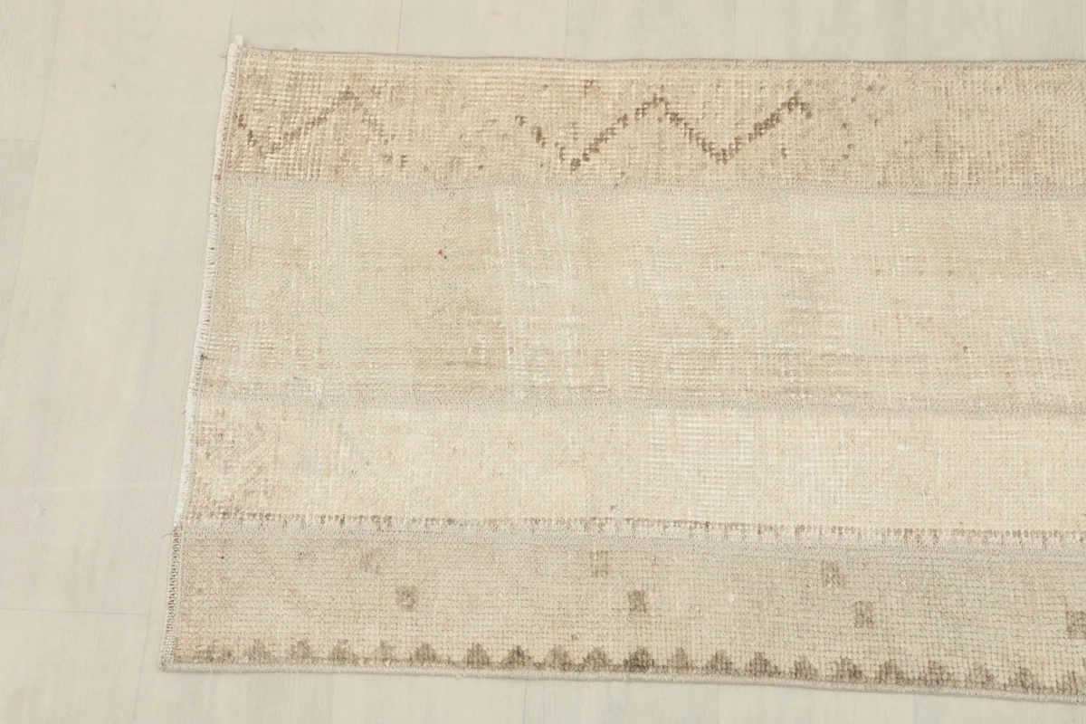 Detail showing the edges and some of the geometric motifs on one side of the rug