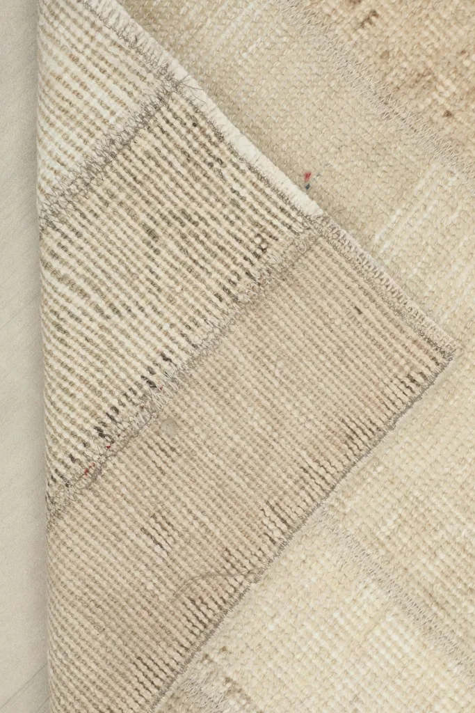 Corner of the rug folded back to show the thickness and construction
