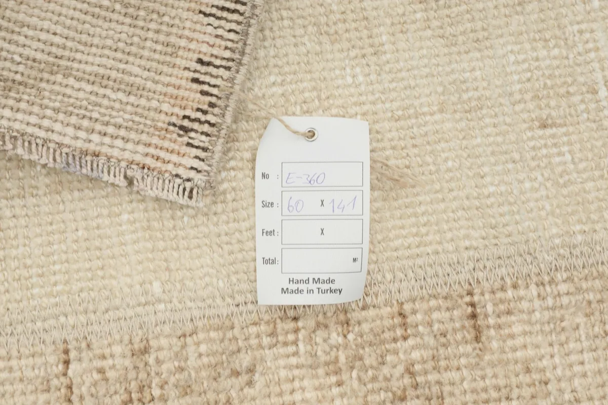 Close-up of the rug with a tag showing its size and 'Hand Made in Turkey'