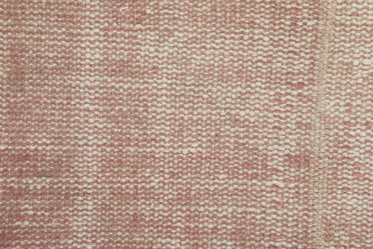 Detailed view of the low wool pile texture, showing the tight hand-knotted construction