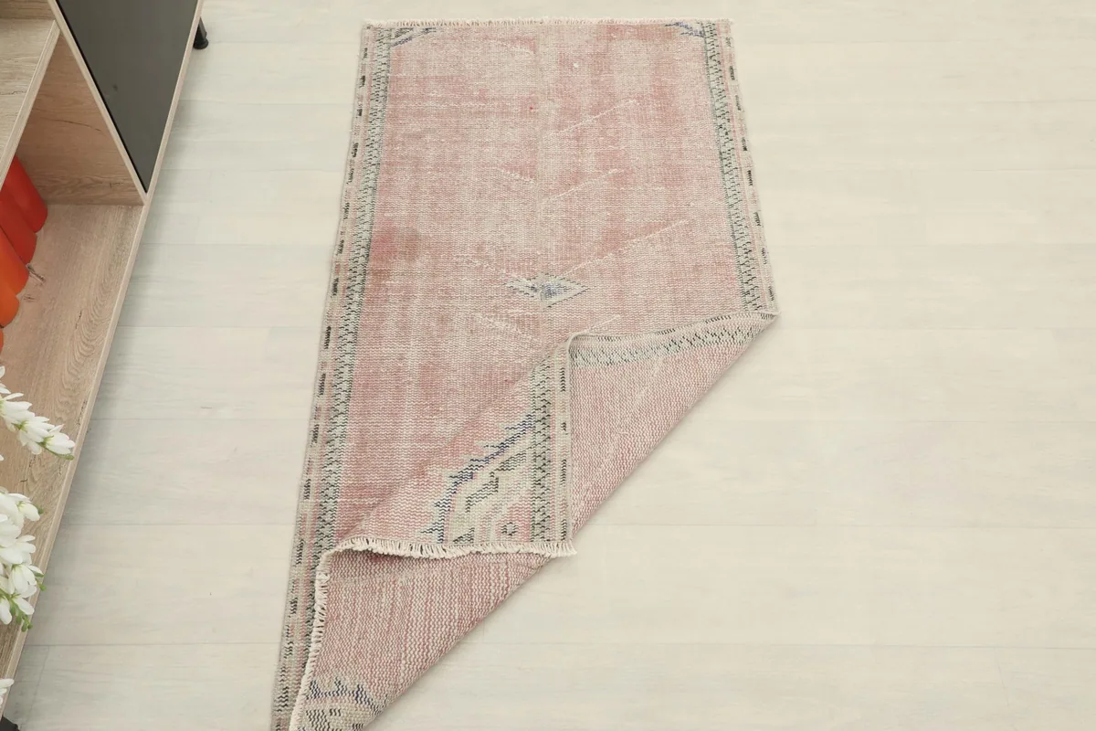 Rug partially folded, demonstrating its flexibility and the overall size in a room setting