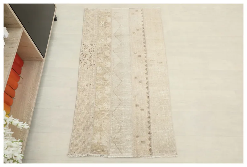 Full overhead view of the beige and tan patchwork vintage Anatolian rug