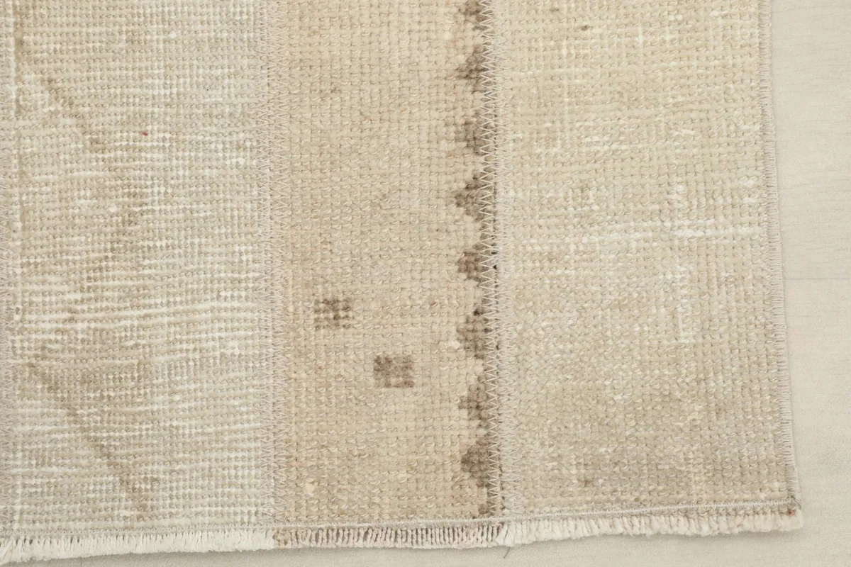 Detailed view of the rug's corner, highlighting the low pile and intricate geometric sections