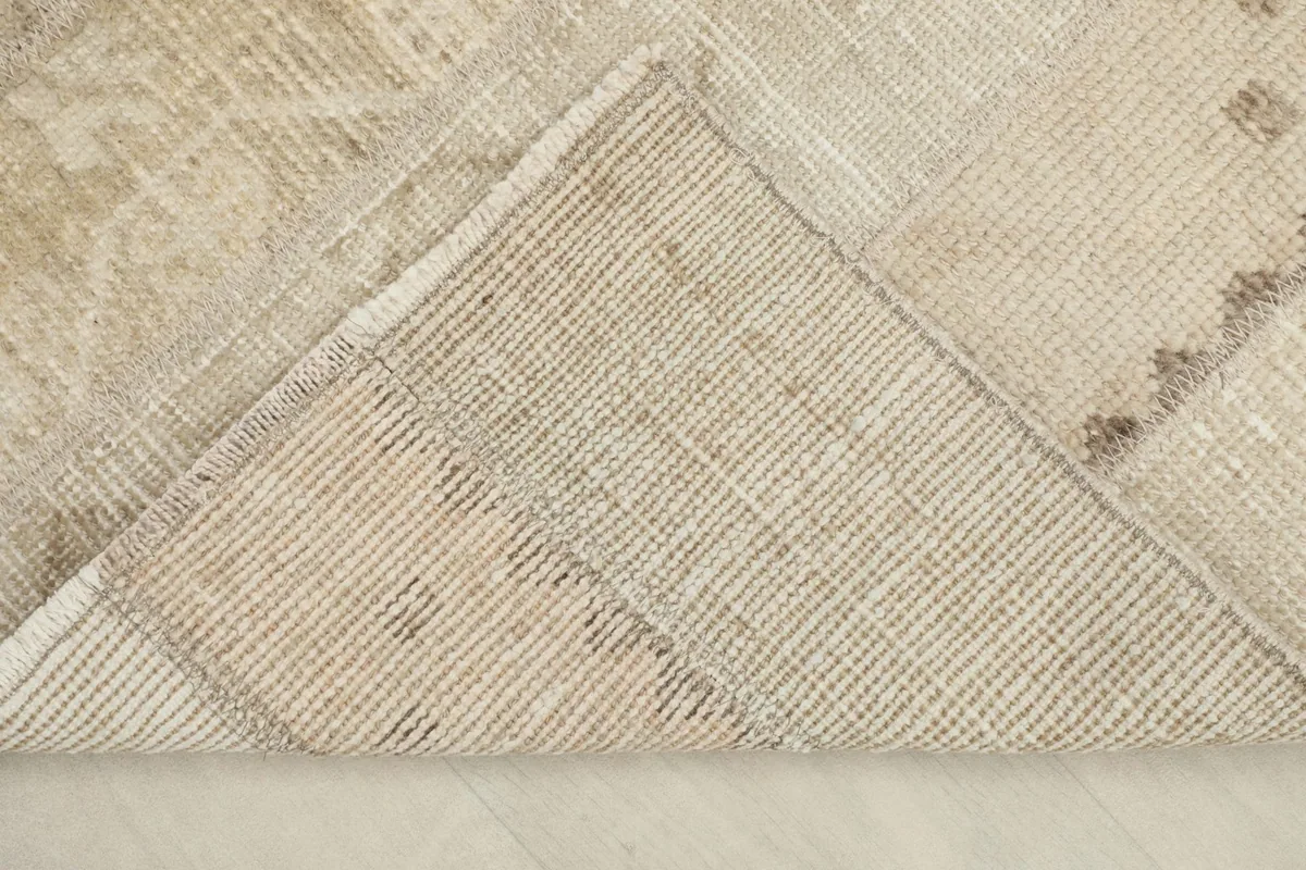 View of the back of the rug, revealing the hand-knotted cotton foundation