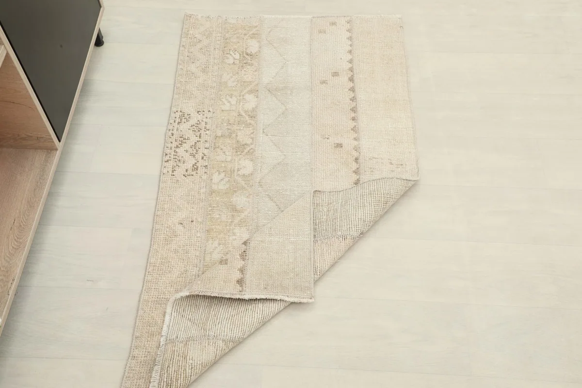 The rug folded to show its flexibility and thickness, with a partial view of the top surface