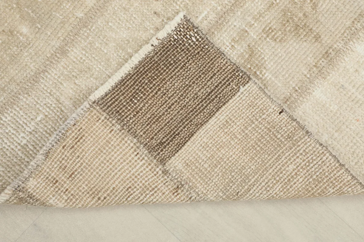 Folded corner showing the cotton foundation and the reverse side of the hand-knotted rug