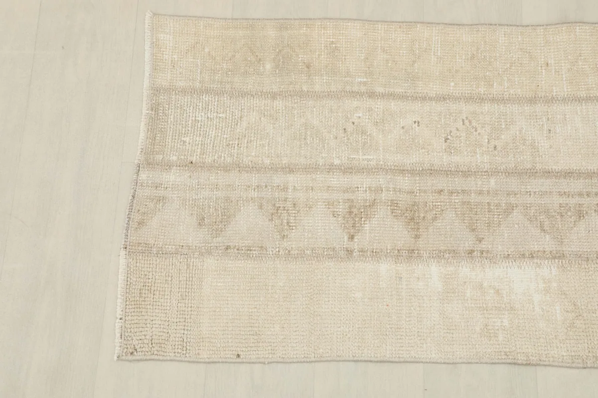 Overhead shot of the rug's other end, revealing the consistent beige coloring and texture