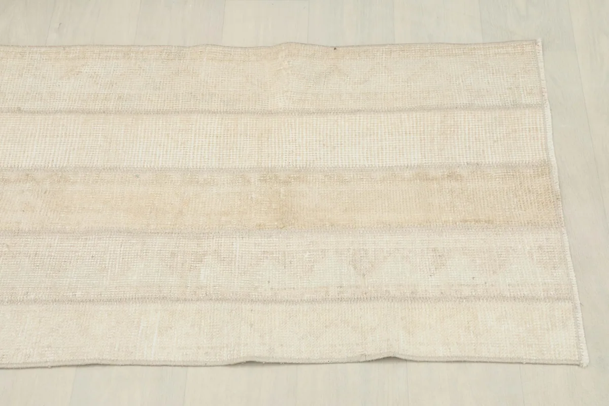 Another overhead perspective, emphasizing the clean lines and muted tones of the vintage rug.