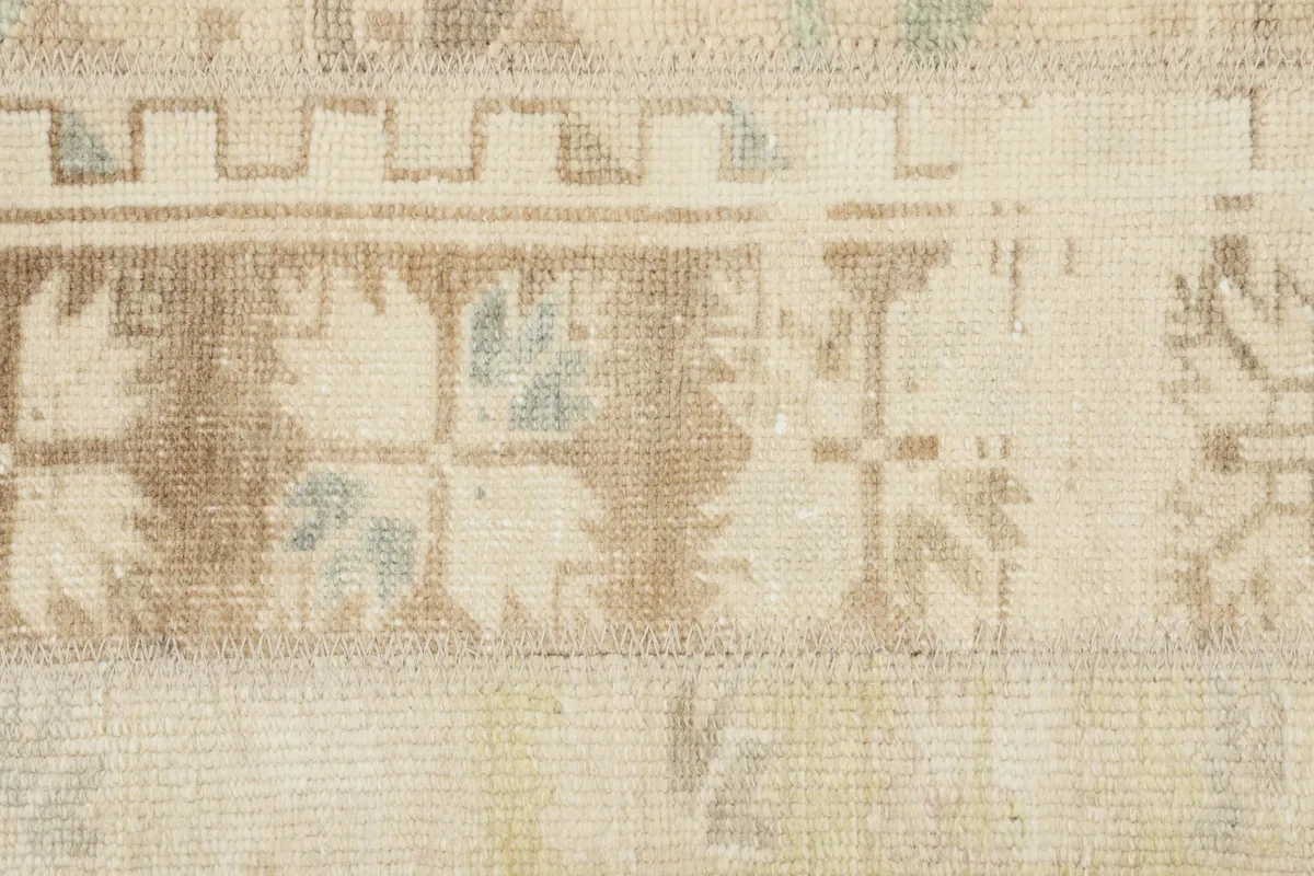 Detailed view of the rug's patchwork sections and tribal patterns