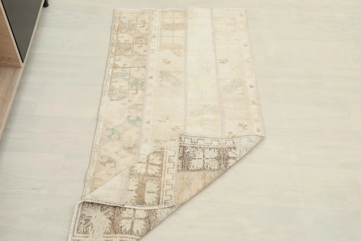 Rug with one corner folded, showing the full length and width from an elevated perspective