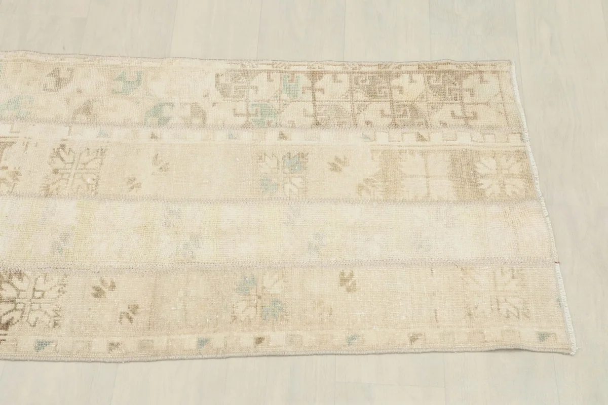 Overhead shot of the other end of the vintage rug, displaying its varied textures and colors