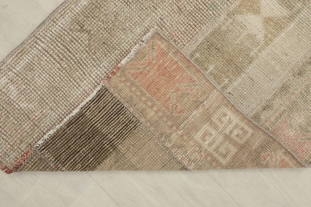 View of the back of the rug, revealing the cotton foundation and the hand-knotted construction.