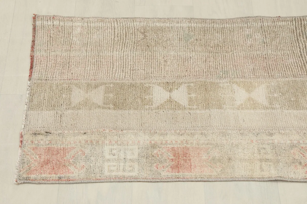 Overhead shot focusing on the central and lower sections of the rug, revealing the patchwork-like design.