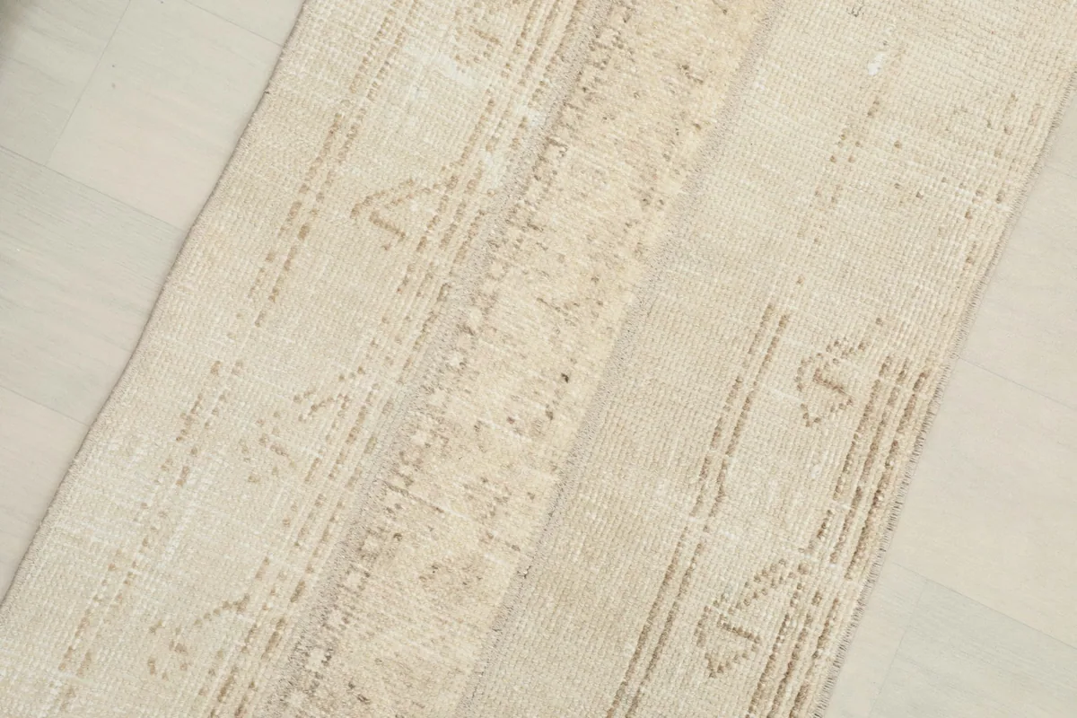 Close-up of the beige and tan tribal motifs and low pile