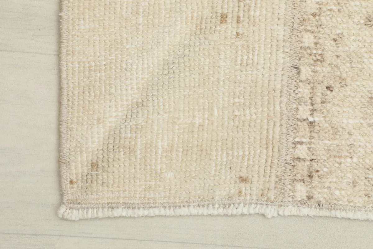 Corner view showing the fringe and edge of the hand-knotted rug