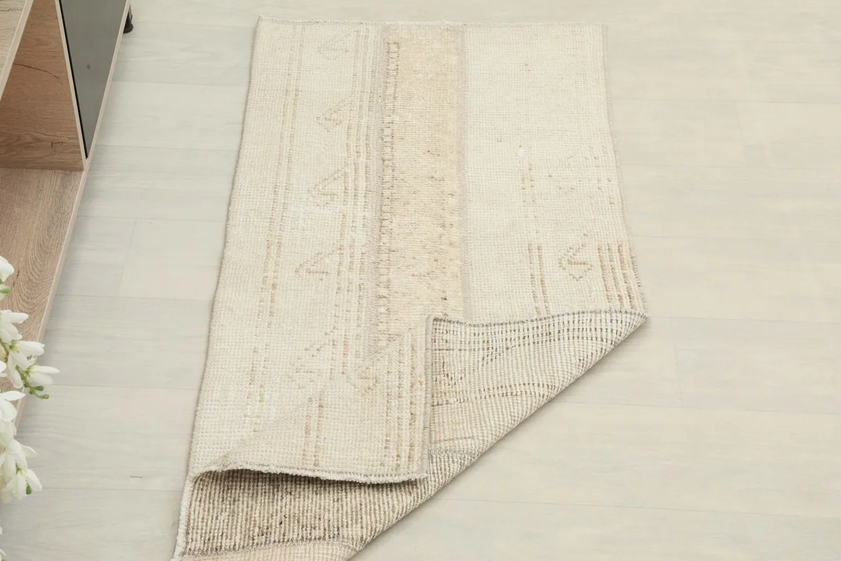 Rug partially folded to show thickness and flexibility of the vintage wool
