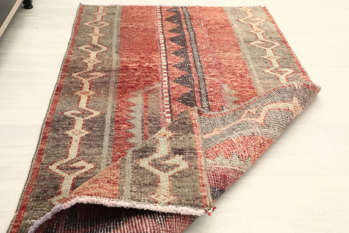 Rug with one corner folded back, illustrating its flexibility and thickness