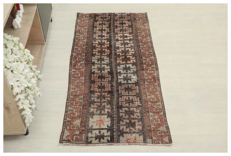 Full top view of the vintage Anatolian area rug with geometric black and rust patterns